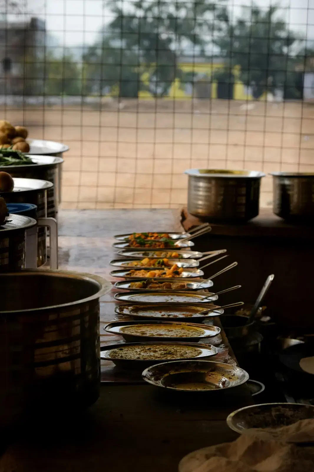 Plates of fresh curries lined up at a roadside eatery in Rajasthan